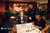 a group of people sitting at a table in a restaurant