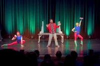 a group of dancers performing on stage