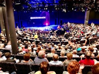 an auditorium full of people watching a performance