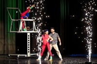 a man and a woman on stage with sparklers