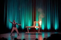 a man on a stage with a table in front of him