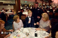 a group of people sitting around a table at a banquet